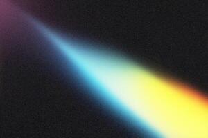 Light beam creating colorful spectrum on dark background photo