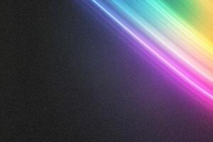 Colorful light trails creating a rainbow effect on dark background photo