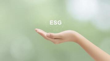Hand reaching out with the letters ESG floating above, symbolizing environmental, social, and governance principles in a modern, abstract context of sustainability and responsibility photo
