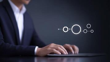 Business professional in dark suit interacts with digital interface, showcasing gears and circles, symbolizing technology and innovation in a modern workspace environment photo