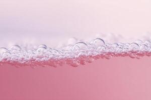 Bubbles of soap on pink background photo