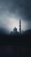Majestic mosque silhouette against a dramatic cloudy sky, surrounded by mountains and reflecting on calm water, creating a serene and spiritual atmosphere photo