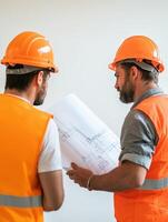 Engineers Engrossed in Blueprint Analysis with Warm Tungsten photo
