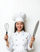 White Uniform Chef Showcasing Culinary Skills with Knife and Whisk photo