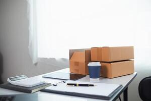 Moving boxes and laptop on desk photo