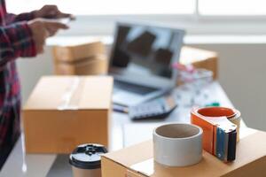 A person is using a laptop and a coffee cup photo