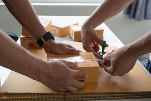 Two people cutting open boxes with scissors photo