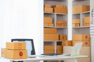A desk with boxes and a laptop on it photo