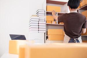 A man is standing in front of a shelf with boxes photo