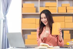 Asian woman holding a box of orange boxes photo