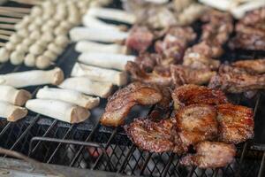 A grill with meat and other food on it photo