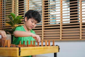 Close up of Boy PlayingBlock Game at Home, Mother and Son Playing Block Game in Living Room, Parent and Child Enjoying Quality Time Together photo