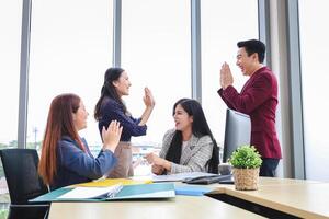 Business Team Meeting in Office, Successful Business Team Celebration, Happy Colleagues Celebrating Success in Office photo
