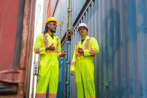 Logistics engineer and foreman worker team in industry containers yard, Dock workers inspecting containers box at shipping container cargo photo