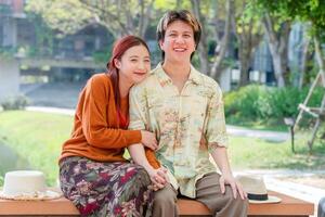 Affectionate Couple Enjoying a Date in the Park, Couple Resting in Park on a Sunny Day photo