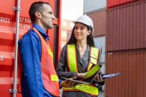 Engineer and foreman working at industry containers cargo, Logistics professional team inspecting containers box at shipping yard photo
