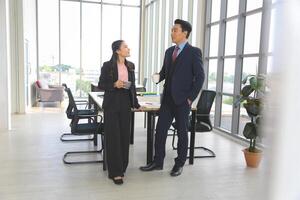 Friendly Conversation Between Coworkers in Office, Business Colleagues Enjoying Coffee Break in Modern Office, Professional Team Chatting During Work Break photo