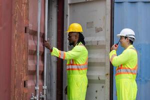 Dock workers man team inspecting containers box at shipping container cargo, Engineer and foreman working in industry containers yard photo