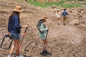 Group of Friends Trekking Through Arid Terrain, Outdoor Adventure in a Drought-Affected Environment photo