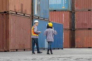 Workers Inspecting Shipping Containers at Storage Facility photo