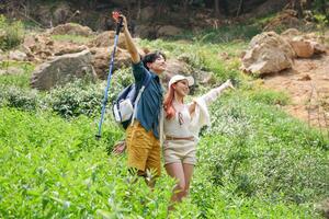 Happy Travelers Exploring Lush Green Mountains, Joyful Couple Enjoying a Scenic Outdoor Adventure, Young Hikers with Arms Outstretched in Nature photo