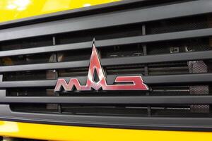 Logotype of the truck of Belarusian manufacture on the car cabin at the exhibition photo