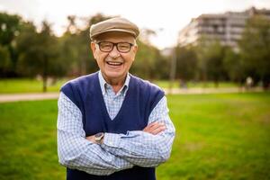 Senior male smiling broadly in a natural park environment, demonstrating joy and active lifestyle in retirement. photo