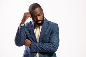 Pensive black male manager with a beard, expressing anxiety and frustration while deep in thought. photo