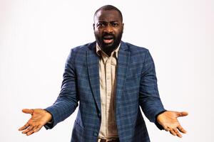 Shocked businessman with wide eyes and open mouth, reacting to unexpected news, isolated on gray background. photo