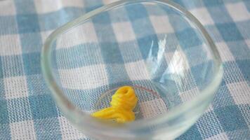 Mustard preparation in a glass bowl on a checkered cloth video