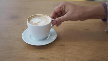 Enjoying a cup of coffee at a cozy cafe table video