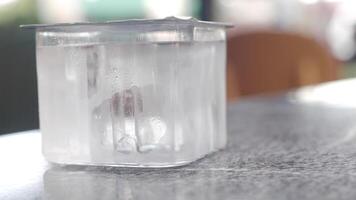 closeup of water in a plastic container on a table video