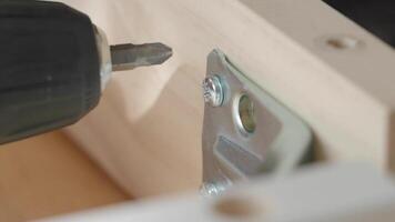 Tips for using a drill to secure brackets in woodworking video