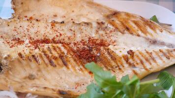 Grilled fish with spices enjoyed at coastal restaurant video
