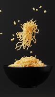 Noodle pasta on black matte floating with dark background photo