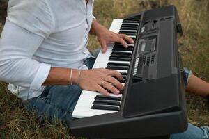 Musician Plays The Keyboard Sitting In The Meadow In Calabria Countryside Outdoor photo