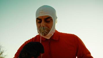 An Astronaut in an Orange Suit Smell a Poisonous Flower on Hostile Planet Outdoor photo