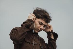 Man Realxing On The Shore During Spring While Listening To Music photo