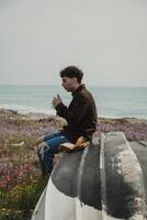 Religious Boy Reading A Prayer On The Bible Book While On The Beach photo