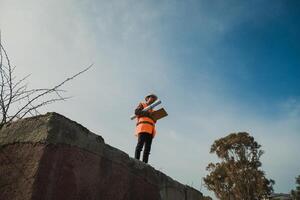 Architect Taking A Look At The Big Project Map Outdoor In The Site photo