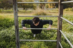 Man Works Out in Spring Outdoors Doing Push Ups Sport Exercise photo