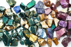 Chalcopyrite mineral samples showcase vibrant colors and intricate textures against a white background photo