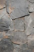 Exploring the rugged beauty of a rough mountainous surface that showcases the intricate layers of natures design photo