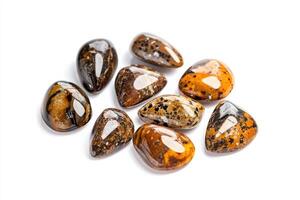 Collection of serpentine stones with unique patterns displayed on a bright white background photo