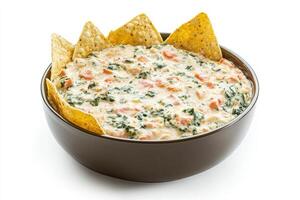 Delicious spinach dip served in a bowl with crispy chips on a clean white background photo