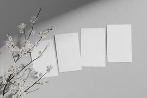 Minimalistic arrangement of four blank posters floating over a sleek gray background with soft shadows photo