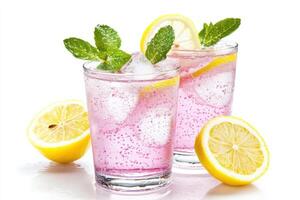 Rose lemonade in two glasses with lemon slices and mint leaves on a bright background photo