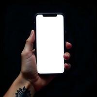 A person holding up a white blank screen on a black background photo