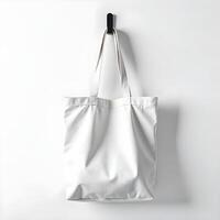 A white tote bag hanging on a wall photo