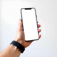 Hand holding a smartphone with blank screen photo